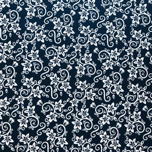 May include: A navy blue fabric with a repeating white floral pattern. The design features stylized flowers, leaves, and swirling vines. The pattern is dense and covers the entire surface, creating a visually rich and detailed textile.
