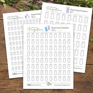 May include: Three sheets of printable royal icing transfers featuring bunny shapes in various sizes. The sheets are printed with black outlines of the bunny shapes on white paper. The text "Royal Icing Transfers" is printed at the top of each sheet, along with the size of the bunny shapes.