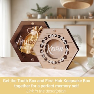 May include: Two hexagonal wooden keepsake boxes with clear acrylic fronts. The dark wood box contains a gold pouch with the text 'Andre' and 'FIRST H 4.17.20'. The light wood box features a circular wreath design and the name 'Kevin' printed in white.