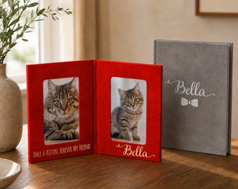 May include: A red felt photo frame with two openings, each displaying a kitten. The frame has the text "ONCE A KITTEN, FOREVER MY FRIEND" and "Bella" in gold script. A gray photo album with "Bella" and a bow tie is also present.