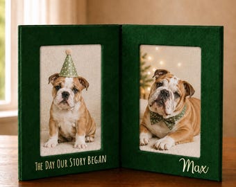 May include: A two-panel green photo frame with two bulldog portraits. One bulldog wears a party hat, the other a bow tie. Text on the frame reads "The Day Our Story Began" and "Max". The frames are on a wooden surface.