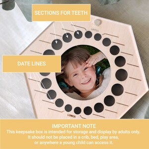 May include: A hexagonal light-colored wooden keepsake box featuring a circular center cutout for a photograph. The frame includes twenty small circular holes labeled UPPER and LOWER for teeth storage, with etched date lines next to each hole.