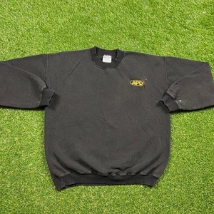 May include: Black sweatshirt with a yellow embroidered logo that says "APD".