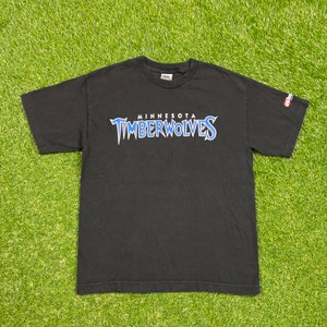 May include: Black t-shirt with a blue and white Minnesota Timberwolves logo.