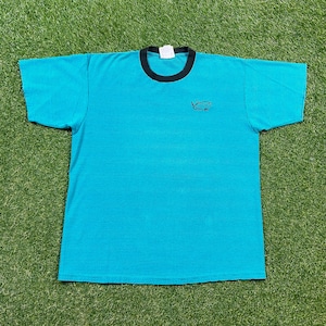 May include: A blue and black striped t-shirt with a small graphic of a boat on the front.