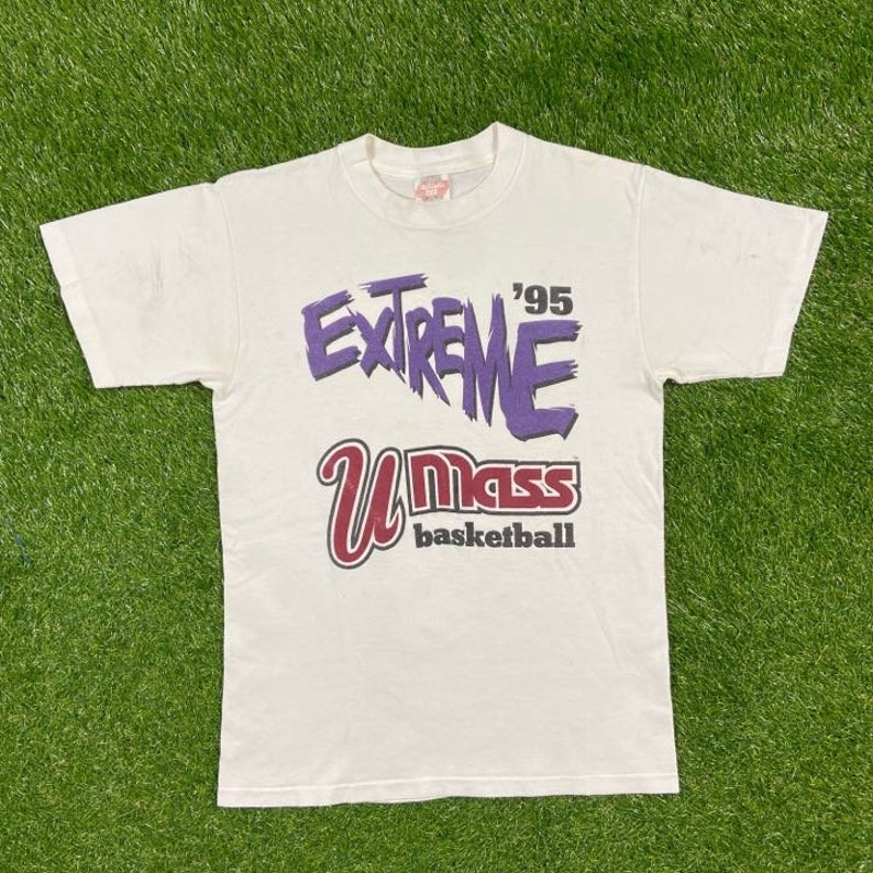 May include: White t-shirt with a purple and white graphic that says "Extreme '95 UMass Basketball".