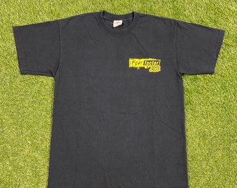 May include: Black t-shirt with a yellow graphic that says "Fear Factor Live"