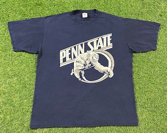 May include: A navy blue t-shirt with a white graphic of a lion and the text "Penn State".