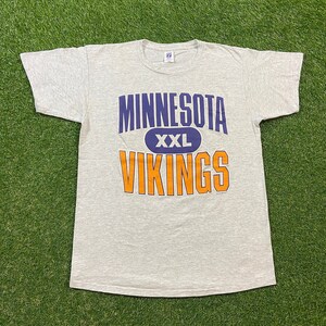 May include: Gray t-shirt with a purple and orange graphic that says "Minnesota XXL Vikings".