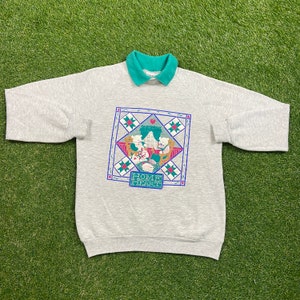 May include: Gray sweatshirt with a green collar and a colorful graphic of two bears sitting in a house with the text "Home Heart".