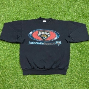 May include: Black sweatshirt with a Jacksonville Jaguars logo and the text "Jacksonville Jaguars".