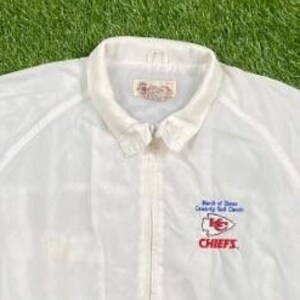 May include: White windbreaker jacket with a zipper closure and a red, white, and blue embroidered logo that says "Bank of America Community Self-Service Chiefs".