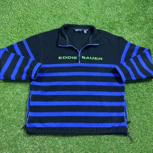 May include: A black and blue striped Eddie Bauer fleece pullover with a half-zip closure.