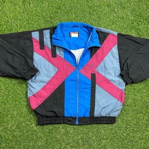 May include: A black, blue, and pink color-blocked windbreaker jacket with a zipper closure.