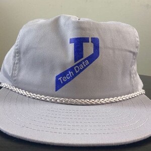 May include: A grey and white baseball cap with a blue logo that says "Tech Data" and a blue "T" in a box.