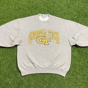 May include: Grey sweatshirt with a yellow and black "Georgia Tech" logo and a yellow "GT" logo.