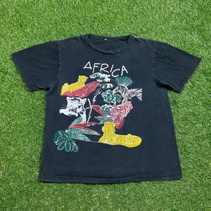 May include: Black t-shirt with a graphic print of animals and plants forming the word "AFRICA".