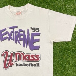 May include: White t-shirt with a purple and red graphic print that says "Extreme '95 UMass Basketball".