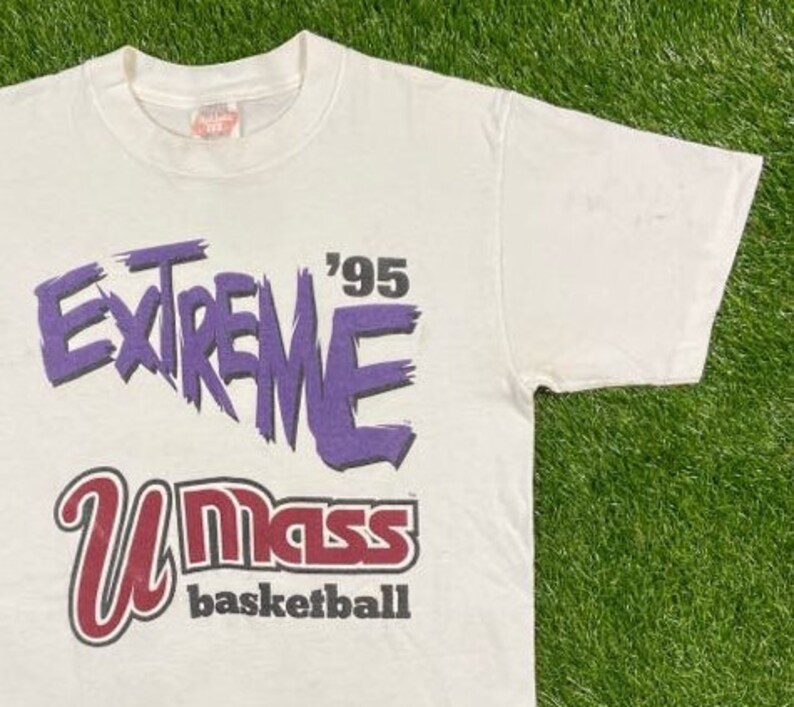 May include: White t-shirt with a purple and red graphic print that says "Extreme '95 UMass Basketball".