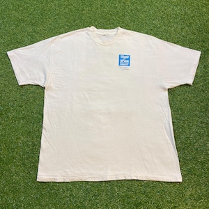 May include: Cream-coloured t-shirt with a crew neck and short sleeves. The shirt has a blue square graphic on the upper left chest with the text "ER Ryder BP Works". The shirt is made of a soft, lightweight material.