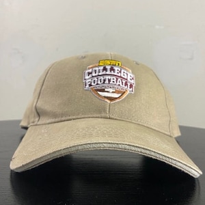 May include: A tan baseball cap with an embroidered patch that says "College Football" in maroon and white lettering with a yellow outline. The patch also features a football and a shield.