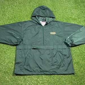 May include: A dark green hooded anorak jacket with a half-zip and a front pocket. The jacket features the word "OREGON" in gold on the chest. Made from a lightweight material, it has a casual style.