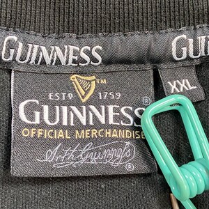 May include: Black t-shirt label featuring the Guinness logo, a gold harp, and the text "ESTD 1759". The label also reads "OFFICIAL MERCHANDISE" and "Arth Guinness". The size is XXL.