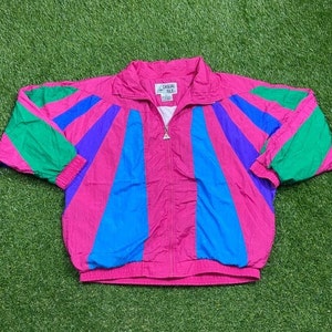May include: A pink, blue, green, and purple striped windbreaker jacket with a zipper closure and the text "Casual Style" on the front.