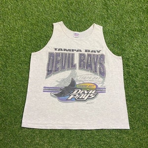 May include: A gray sleeveless shirt with a vintage Tampa Bay Devil Rays logo. The logo features a blue stingray with the words "Tampa Bay Devil Rays" in purple and yellow.