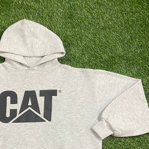 May include: A gray hooded sweatshirt with a black CAT logo on the front. The logo is a stylized letter C with a triangle inside.