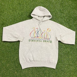 May include: A grey hooded sweatshirt with a graphic of sailboats and the text "VIRGINIA BEACH" on the front.