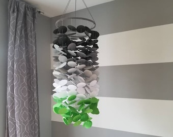 Baby mobile in dark gray to white with green at the bottom. Boys room Nursery. Decoration for children's rooms. Decorative paper mobile.