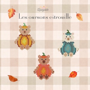 May include: A cross-stitch pattern titled Les oursons citrouille featuring three pixelated bears dressed in pumpkin-themed outfits in orange, yellow, and teal colors, accented with small autumn leaves on a light beige and white checkered background.