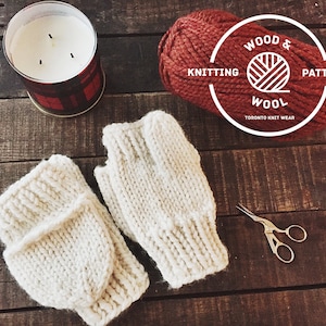 May include: A pair of white knitted fingerless gloves with a brown ball of yarn and a label that reads "Wood & Wool Knitting Pattern Toronto Knit Wear".