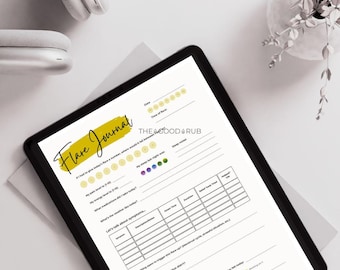 May include: A digital tablet displaying a "Flare Journal" template with sections for tracking symptoms, mood, and sleep. The journal is on a white surface, with white headphones and a small plant in the background.