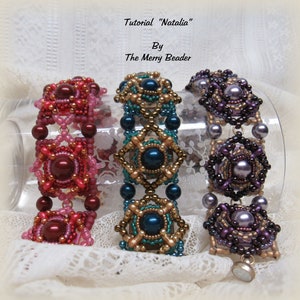 May include: Three beaded bracelets in different colors. The bracelet on the left is red and pink, the middle bracelet is teal and gold, and the bracelet on the right is purple and gold. The bracelets are all made with small beads and have a square shape.
