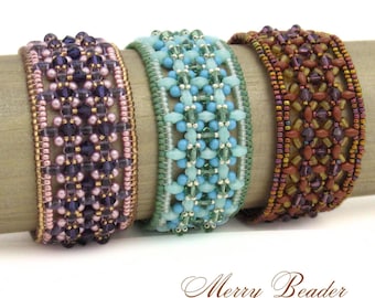 May include: Three beaded cuff bracelets in shades of purple, turquoise, and brown. The bracelets are made with small beads and crystals, and are displayed on a wooden dowel. The text "Merry Beader" is at the bottom.