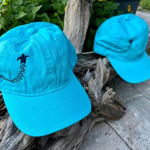 Bonés, pegadas de tartaruga marinha e filhotes