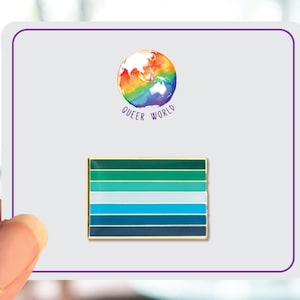 May include: A green, blue, and white enamel pin with a rainbow globe and the text "Queer World" on a white background.