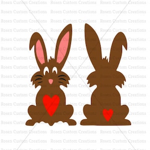 May include: Two brown bunny silhouettes with red hearts. The bunny on the left is facing forward with its ears up and a heart on its chest. The bunny on the right is facing away with its ears down and a heart on its back.