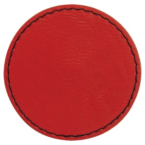 May include: Red leather coaster with a black stitched edge.