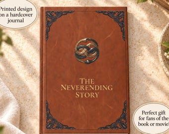 May include: A brown hardcover journal featuring a gold-colored Auryn symbol of two intertwined snakes at the center. The text THE NEVERENDING STORY is printed in gold below the symbol. Dark ornate corner flourishes decorate the front cover.