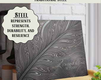 May include: A rectangular glass cutting board featuring a gray and white marbled feather pattern. The text reads: PERFECT 11TH ANNIVERSARY GIFT TRADITIONAL STEEL, STEEL REPRESENTS STRENGTH, DURABILITY, AND RESILIENCE, and JOHNNY & JUNE 11 YEARS.