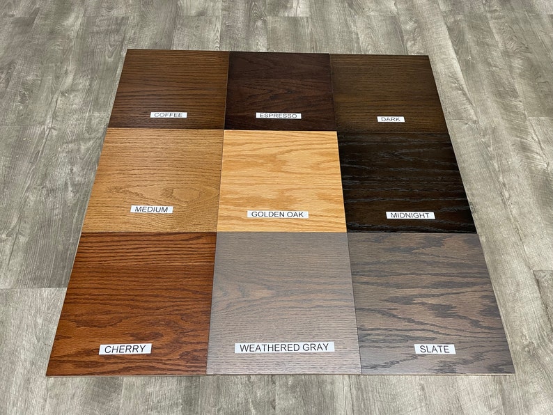 May include: Nine wood stain samples in various shades of brown, gray, and black. The samples are labeled with the following names: Coffee, Espresso, Dark, Medium, Golden Oak, Midnight, Cherry, Weathered Gray, and Slate.