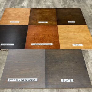 May include: Wood stain color samples in various shades of brown, gray, and black. The samples are labeled with the following names: Medium, Coffee, Dark, Midnight, Vintage Cherry, Pecan, Weathered Gray, and Slate.