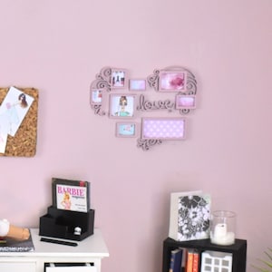 May include: A white desk with a white chair and a doll sitting in the chair. The desk has a lamp, a magazine rack, and a small bookshelf. The wall behind the desk has a corkboard with pictures and a heart-shaped picture frame with the word "love" in it.