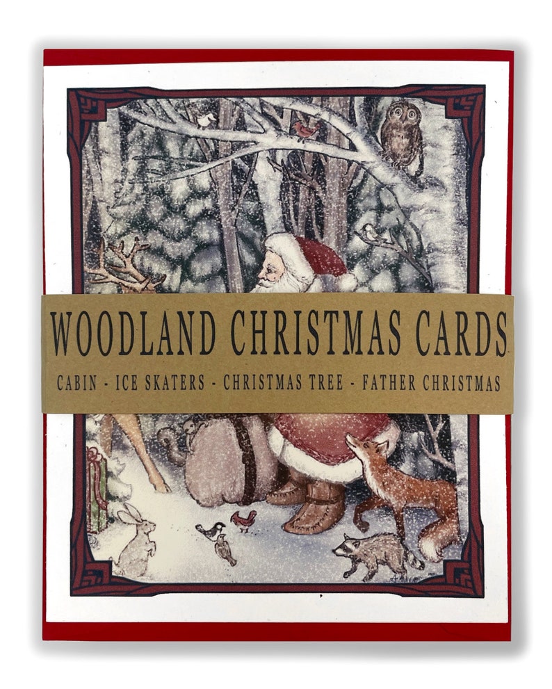 May include: A set of Christmas cards featuring a woodland scene with Santa Claus, a reindeer, a fox, a raccoon, and other animals. The cards are red with a gold border and the text "Woodland Christmas Cards" in gold. The text below the title reads "Cabin - Ice Skaters - Christmas Tree - Father Christmas".