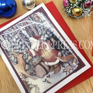 May include: A Christmas card featuring a snowy forest scene with Santa Claus, a deer, a fox, and other woodland creatures. Santa is carrying a bag of gifts and a lantern. The card has a red border and a white background.
