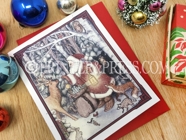 May include: A Christmas card featuring a snowy forest scene with Santa Claus, a deer, a fox, and other woodland creatures. Santa is carrying a bag of gifts and a lantern. The card has a red border and a white background.
