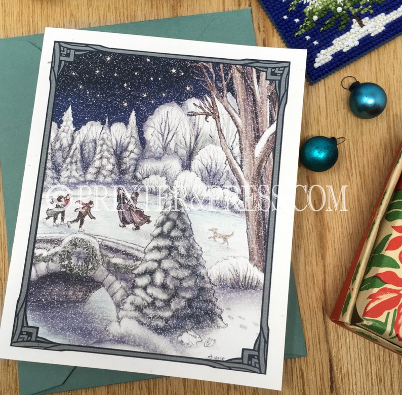 May include: A snowy winter scene with a group of people ice skating on a frozen pond. The scene is framed by a dark gray border and includes a large snow-covered tree in the foreground. The sky is dark blue with white stars and falling snow.
